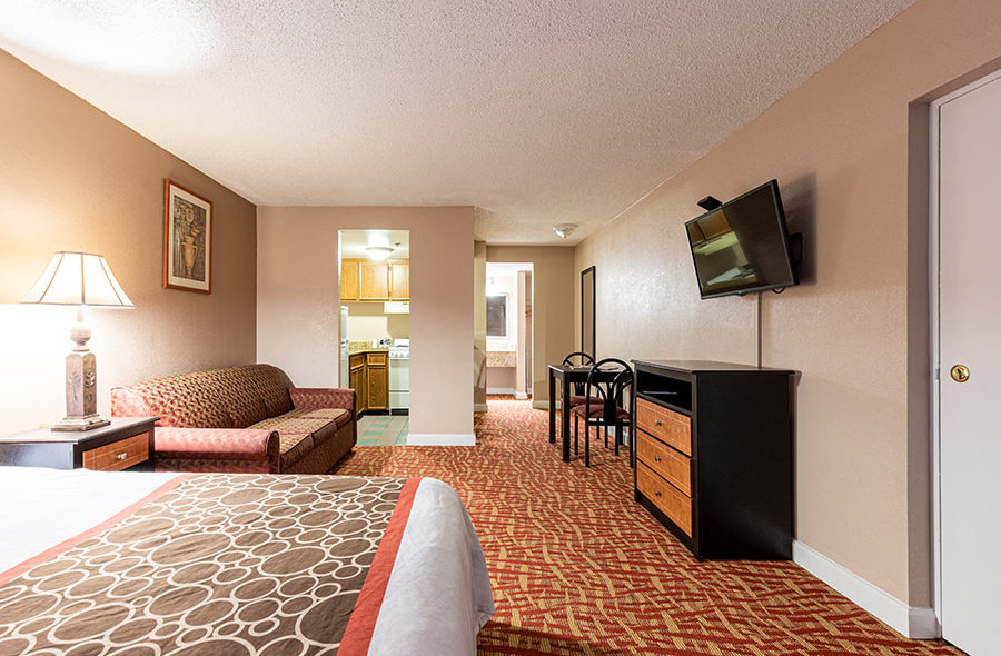 Image of bedroom in our Deluxe King Bed Efficiency room at Sundial Inn.
